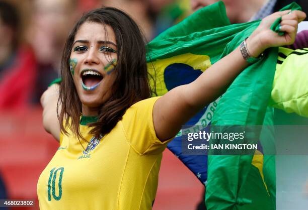 topshot-a-brazilian-fan-awaits-kick-off-in-the-friendly-international-football-match-between.jpg